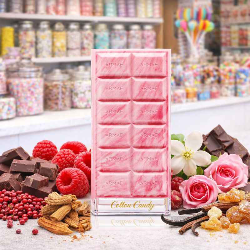 Armaf Cotton Candy frasco rodeado de frambuesas, cacao y dulces sobre mesa